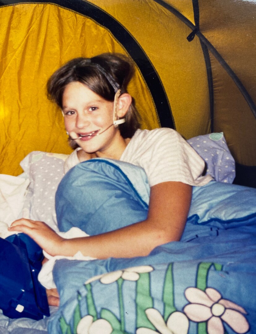 Photo of Lucy Denyer, age 12, in a yellow tent.